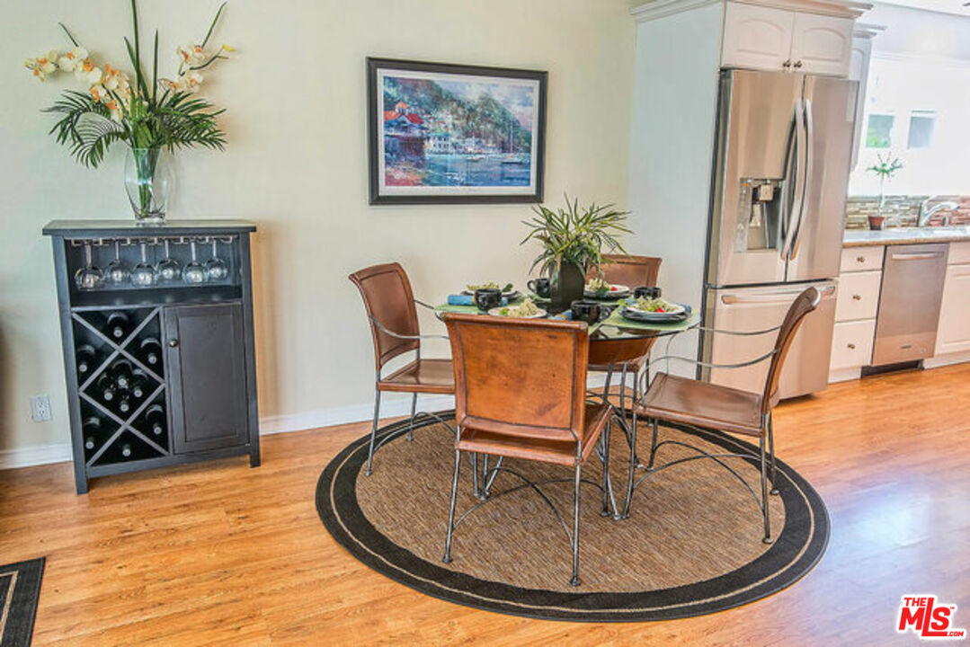 7830 West 83rd Street Playa del Rey, CA 90293 - Photo 20 of 74 a dining room with furniture potted plants and wooden floor