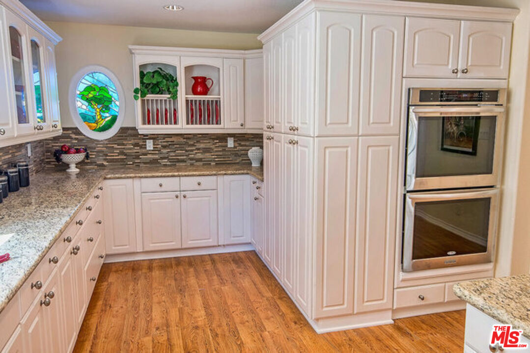 7830 West 83rd Street Playa del Rey, CA 90293 - Photo 26 of 74 a kitchen with white cabinets and appliances