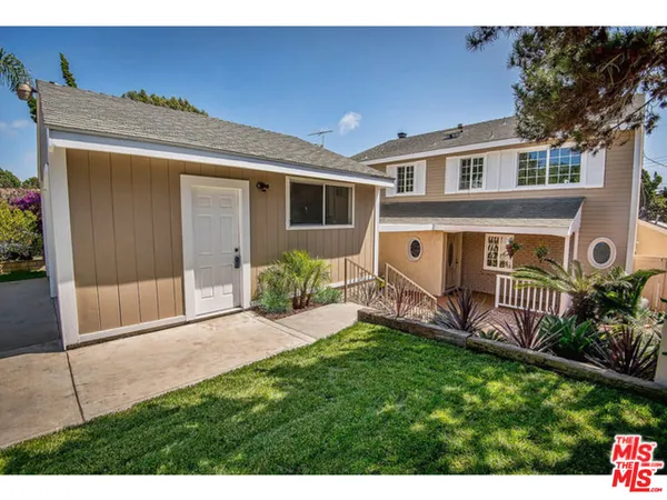 a view of a house with backyard porch and sitting area