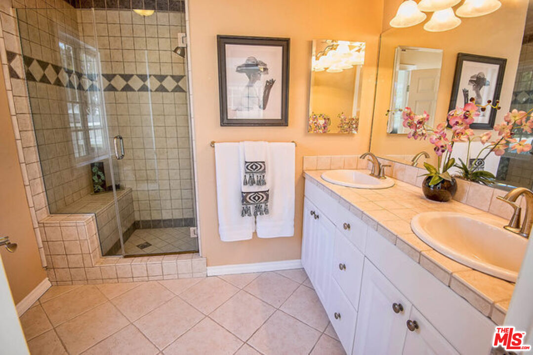 7830 West 83rd Street Playa del Rey, CA 90293 - Photo 40 of 74 a spacious bathroom with a double vanity sink a mirror and shower