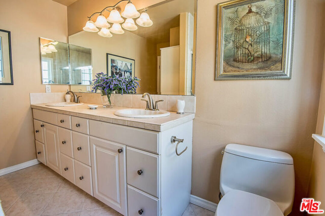 7830 West 83rd Street Playa del Rey, CA 90293 - Photo 44 of 74 a bathroom with a toilet sink and mirror