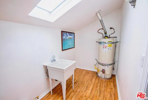 a kitchen with stainless steel appliances granite countertop a refrigerator a stove and a wooden floors