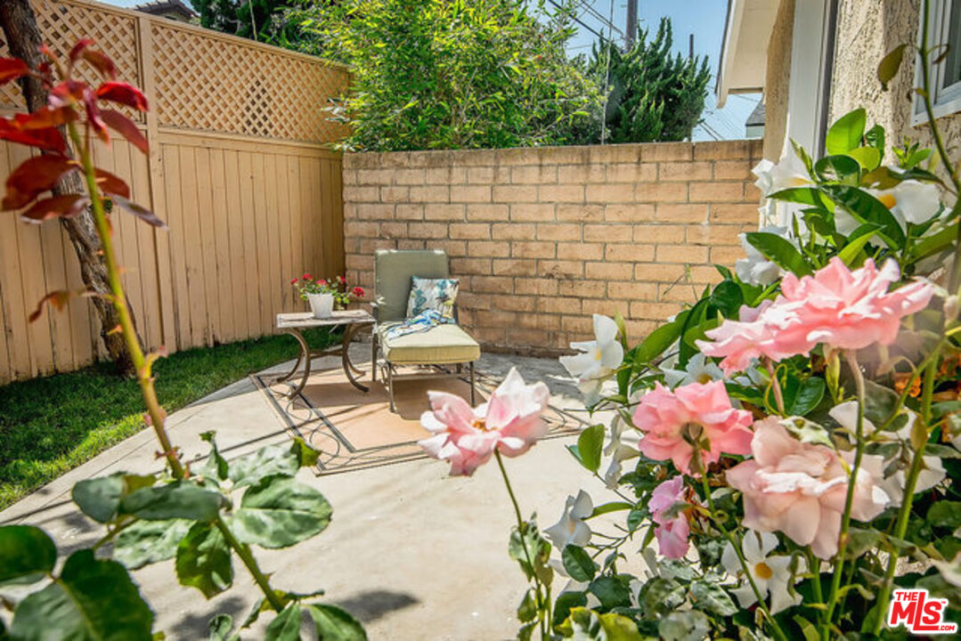 7830 West 83rd Street Playa del Rey, CA 90293 - Photo 47 of 74 a backyard of a house with a garden and outdoor seating