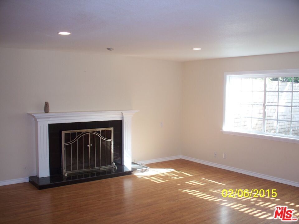 7830 West 83rd Street Playa del Rey, CA 90293 - Photo 60 of 74 a view of an empty room with wooden floor fireplace and a window