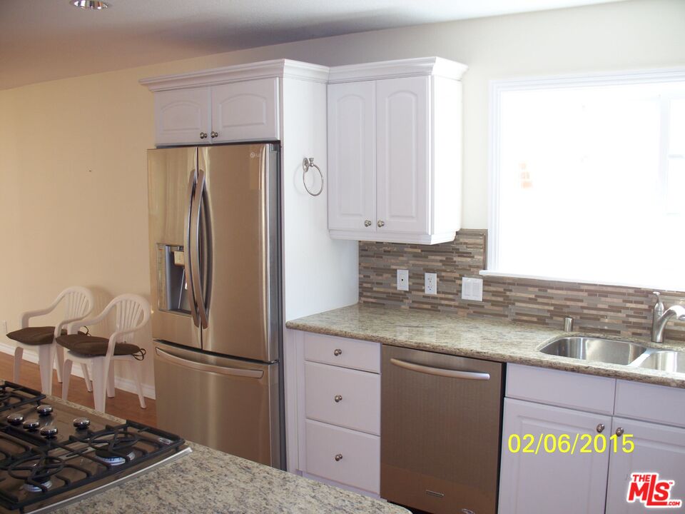 7830 West 83rd Street Playa del Rey, CA 90293 - Photo 65 of 74 a kitchen with stainless steel appliances granite countertop a refrigerator and a stove
