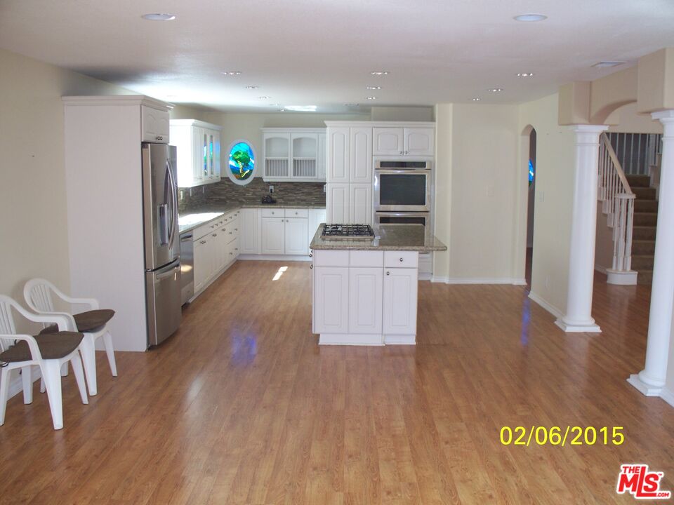 7830 West 83rd Street Playa del Rey, CA 90293 - Photo 67 of 74 a kitchen with stainless steel appliances granite countertop a refrigerator a stove and a wooden floors
