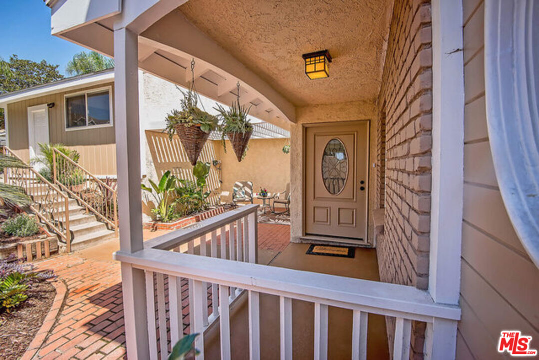7830 West 83rd Street Playa del Rey, CA 90293 - Photo 7 of 74 a front view of a house with a glass door