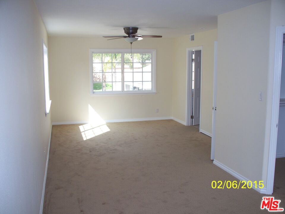 7830 West 83rd Street Playa del Rey, CA 90293 - Photo 72 of 74 an empty room with windows and chandelier fan