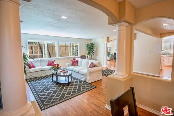 a living room with furniture and flowers