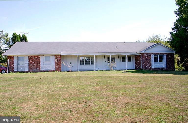1907 Ridgewood Court Hampstead, MD 21074 - Photo 1 of 25 a front view of a house with a garden