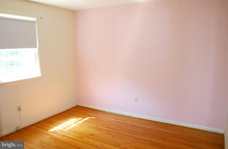 1907 Ridgewood Court Hampstead, MD 21074 - Photo 11 of 25 a view of an empty room with wooden floor and a window