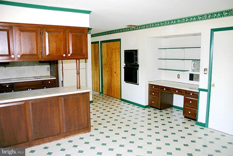 1907 Ridgewood Court Hampstead, MD 21074 - Photo 3 of 25 a kitchen with stainless steel appliances a sink a stove a refrigerator a cabinets and wooden floor