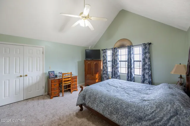 a bed room with a bed and a chandelier
