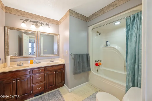 a living room with furniture a flat screen tv and a window