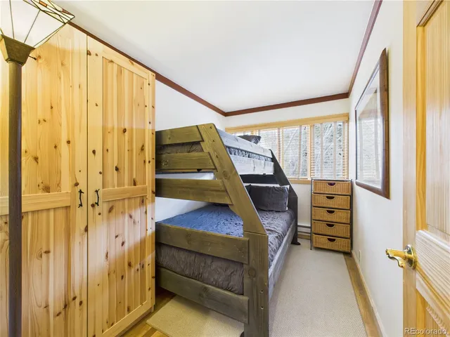 a bedroom with a bed and glass window