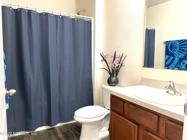 a bathroom with a sink a mirror and a toilet