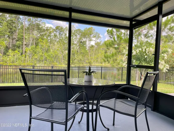a view of a room with a table and chairs