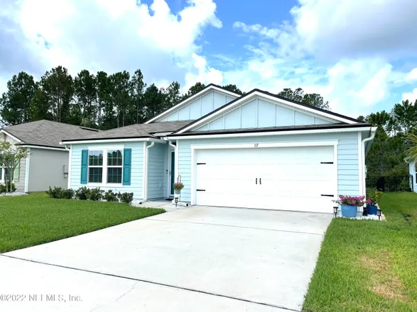 a view of a house with backyard and sitting area