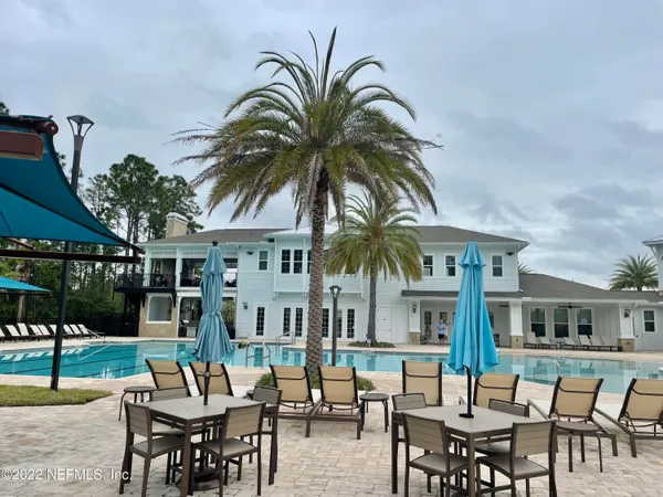 a view of a swimming pool with outdoor seating
