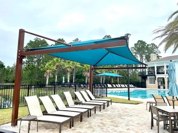 a view of a swimming pool and a yard