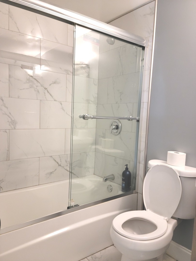 286 Seabury Road Bolingbrook, IL 60440 - Photo 11 of 15 a white toilet and tub next to a bathroom