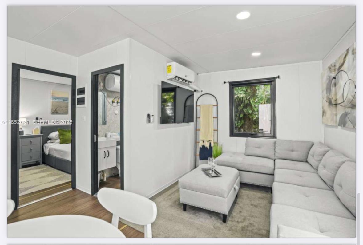 0 Golden Gate Estate, Unit 46 Naples, FL 34120 - Photo 13 of 16 a living room with furniture and a large window