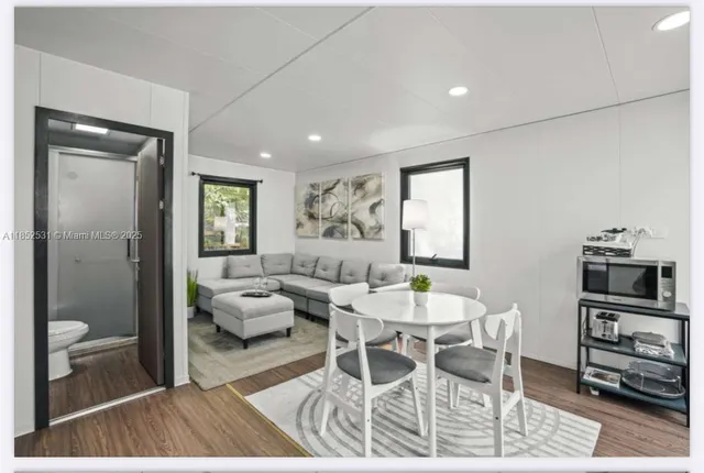 a living room with furniture a window and a flat screen tv