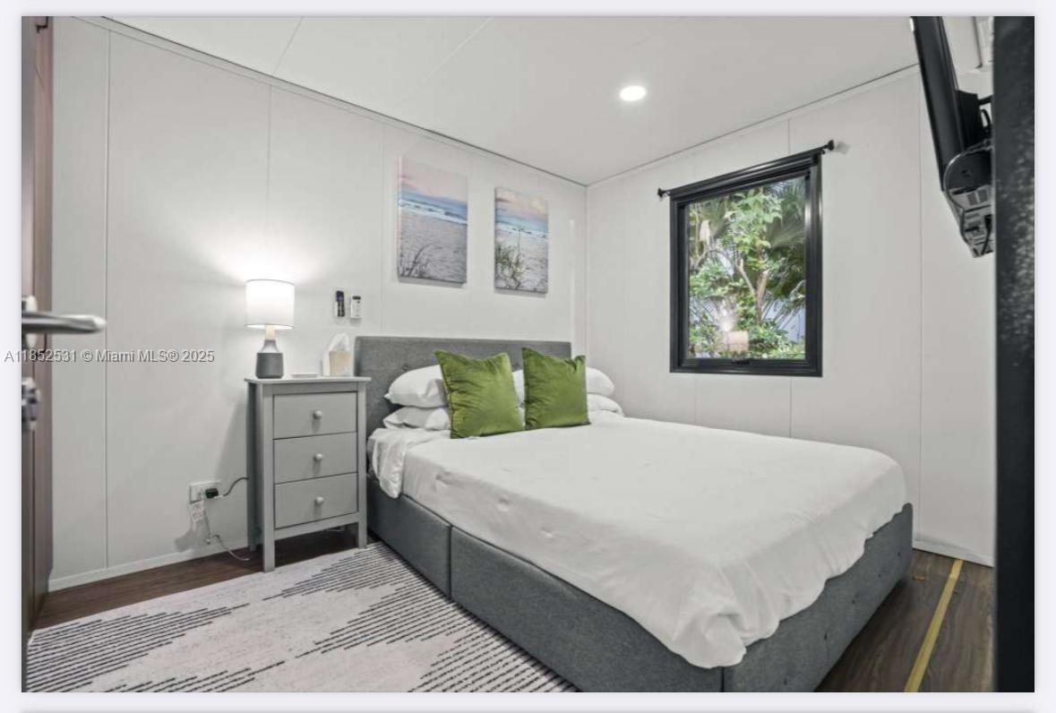 0 Golden Gate Estate, Unit 46 Naples, FL 34120 - Photo 2 of 16 a bedroom with a large bed and a window