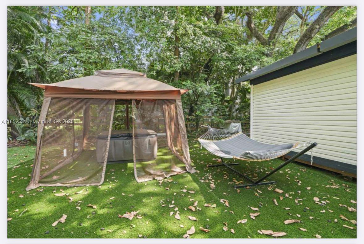 0 Golden Gate Estate, Unit 46 Naples, FL 34120 - Photo 5 of 16 a view of a backyard with a garden
