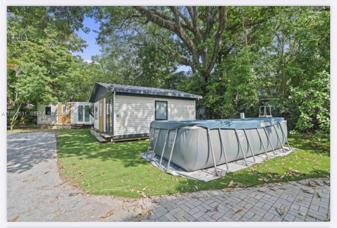 0 Golden Gate Estate, Unit 46 Naples, FL 34120 - Photo 6 of 16 a view of a backyard with a garden and entertaining space