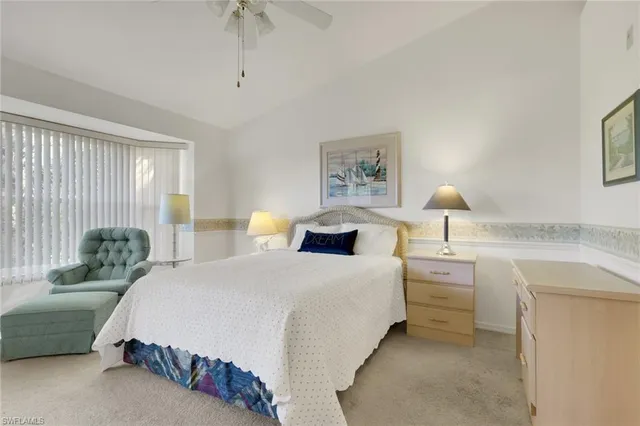 a spacious bedroom with a bed and a chandelier