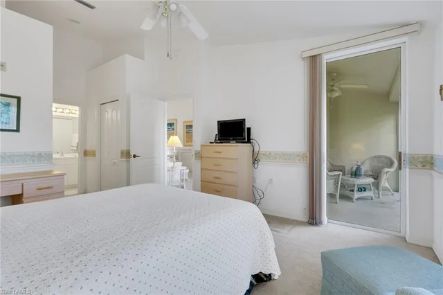 a spacious bedroom with a bed and a view of bathroom