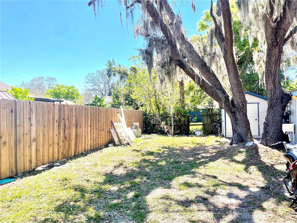 307 South Hiawassee Road Orlando, FL 32835 - Photo 11 of 13 a view of a backyard with a tree