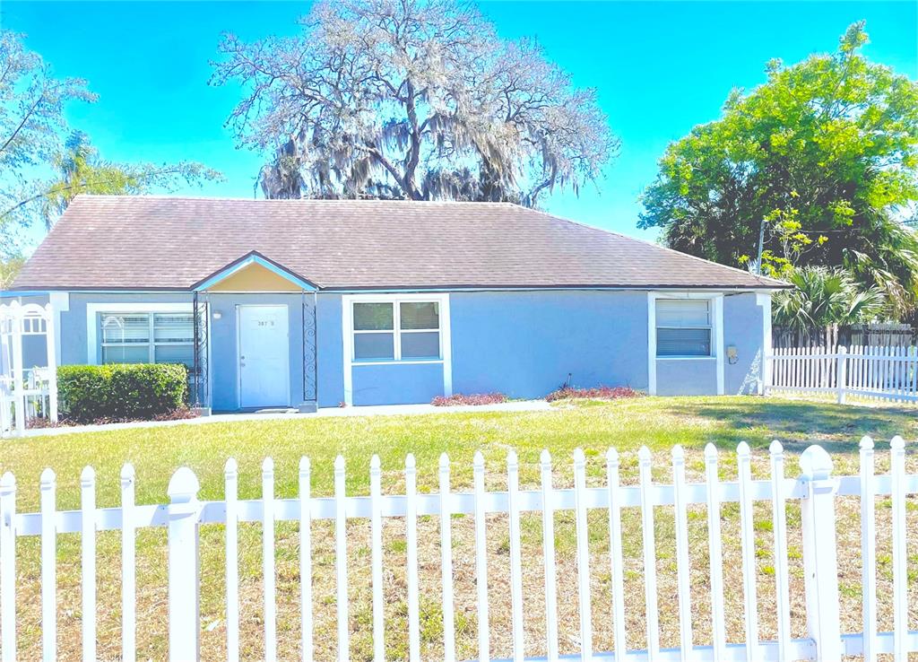 307 South Hiawassee Road Orlando, FL 32835 - Photo 2 of 13 a front view of a house with a yard