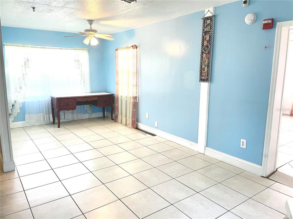 307 South Hiawassee Road Orlando, FL 32835 - Photo 3 of 13 a bedroom with a bed and a window