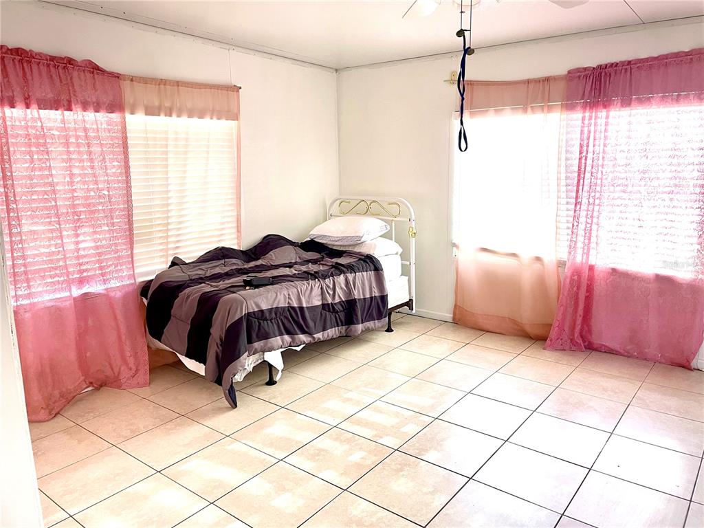 307 South Hiawassee Road Orlando, FL 32835 - Photo 4 of 13 a bedroom with a bed and a window