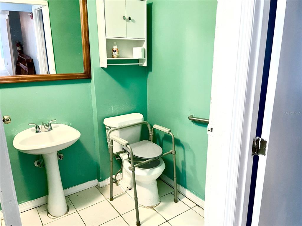 307 South Hiawassee Road Orlando, FL 32835 - Photo 7 of 13 a bathroom with a toilet sink and mirror