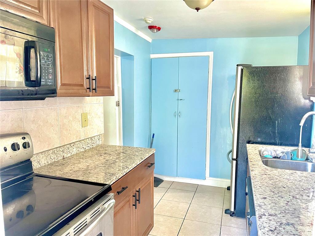 307 South Hiawassee Road Orlando, FL 32835 - Photo 10 of 13 a kitchen with a refrigerator and countertop