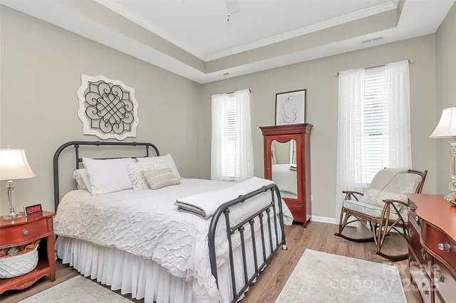 a bedroom with a bed a couch and dresser