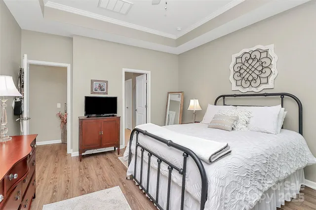 a bedroom with a bed and a television