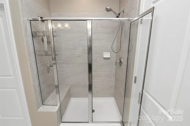 a bathroom with a shower and a glass door