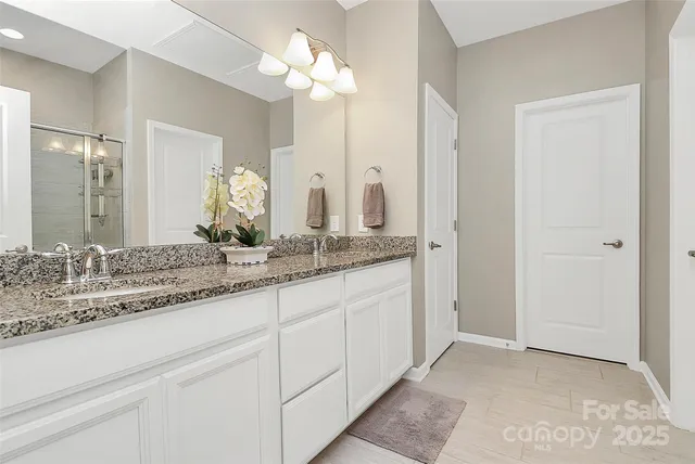 a bathroom with a double vanity sink and a mirror