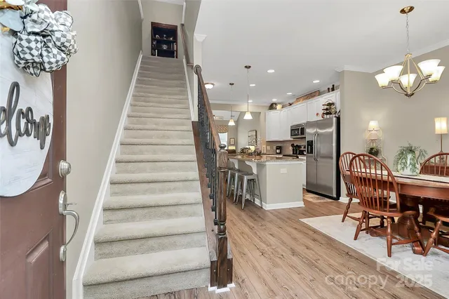 a view of a dining room with furniture and a chandelier