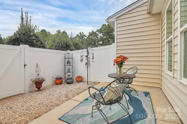 a view of a chairs and table in the balcony