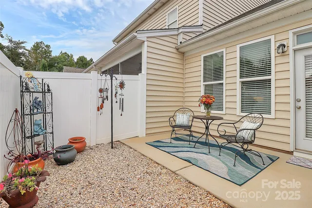 a view of a house with backyard and sitting area
