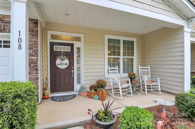 a view of a chairs and table in a back yard