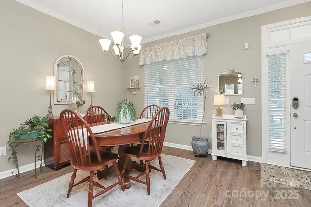 a view of a dining room with furniture and chandelier