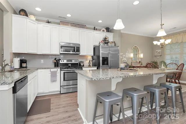 a kitchen with cabinets a sink and appliances