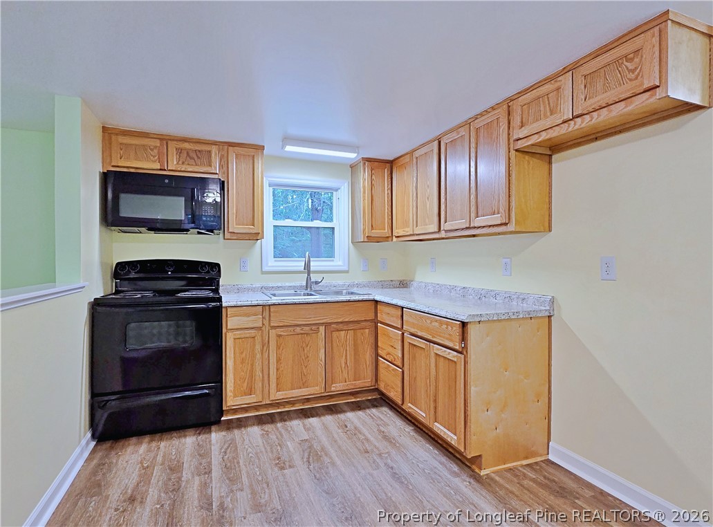 1031 Pine Acres Road White Oak, NC 28399 - Photo 10 of 29 a kitchen with stainless steel appliances granite countertop a stove a sink and a microwave