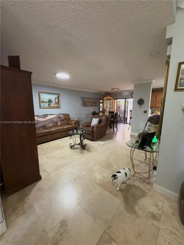 a living room with furniture gym equipment and a flat screen tv